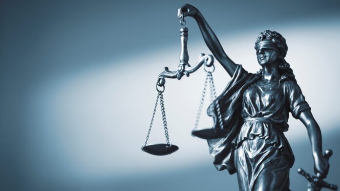 Figure of Justice holding scales and a sword